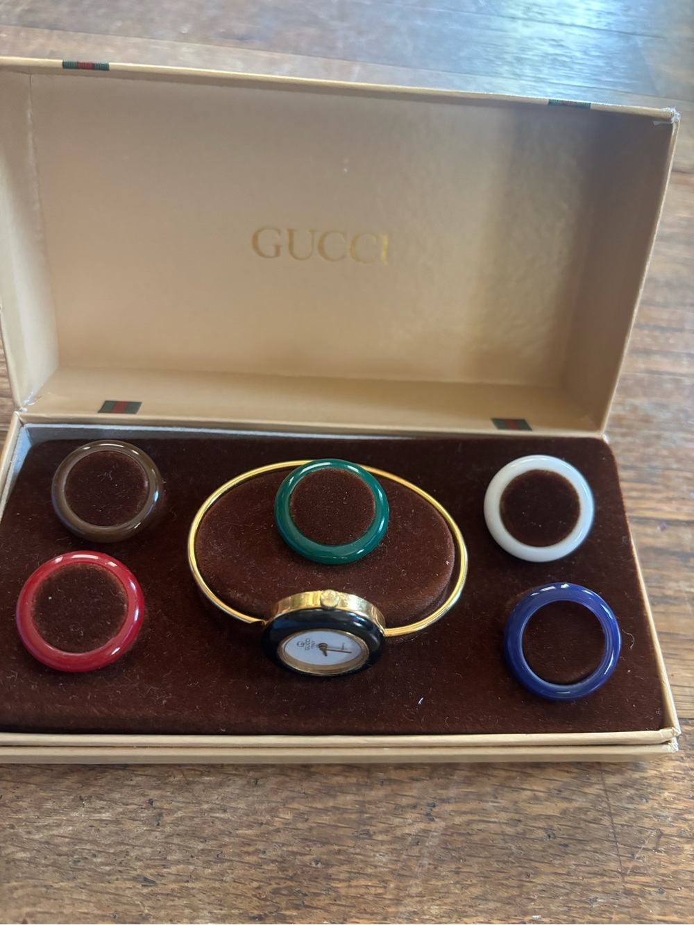 Gucci Gold-Tone Bangle Watch with Red, Green, Blue, White, Brown Rings
